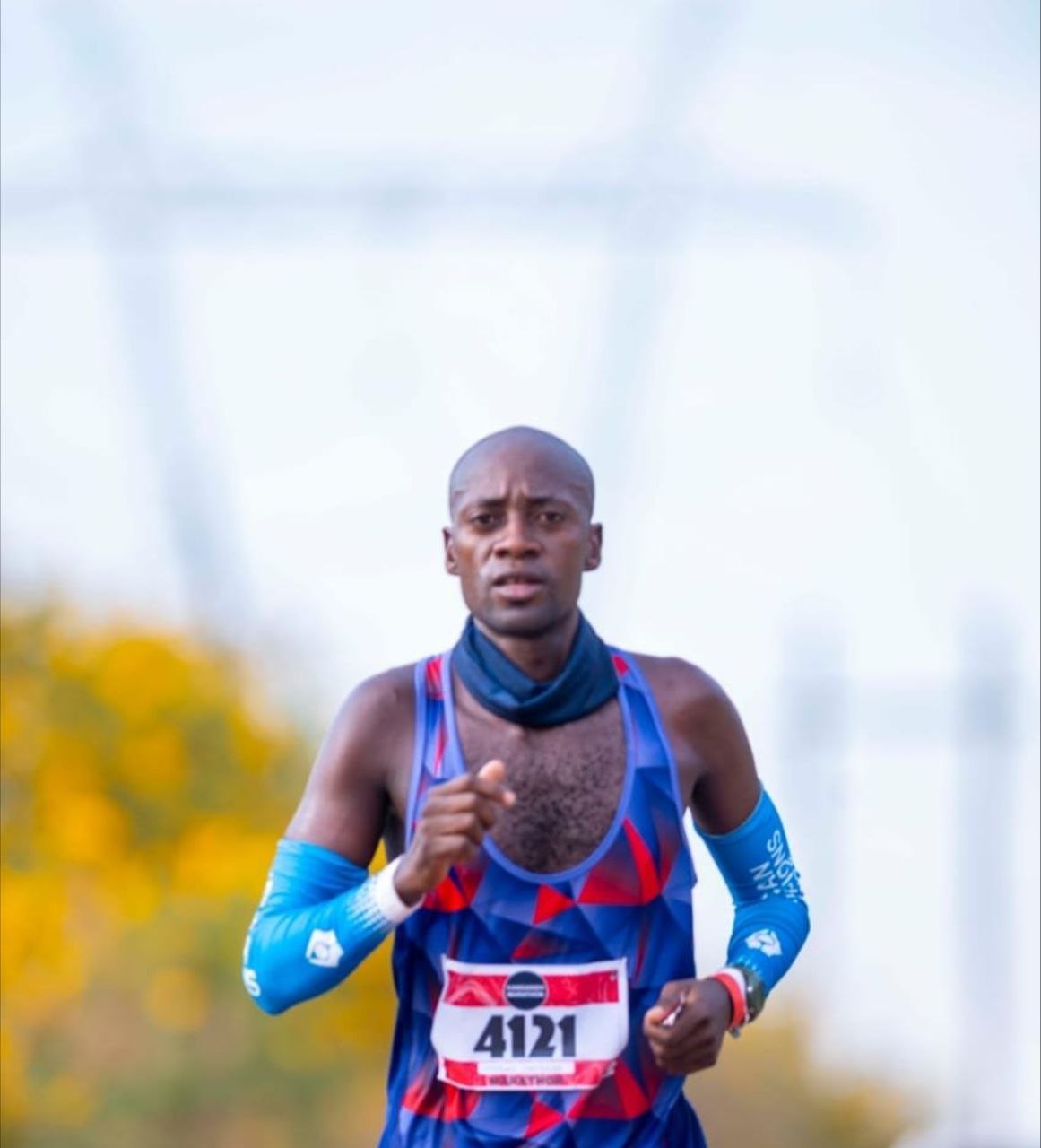 A runner in compression sleeves in the closing kilometres of a race